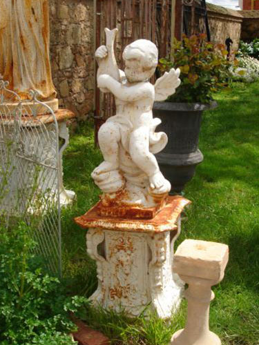 A Iron cherubs statue on pedestal